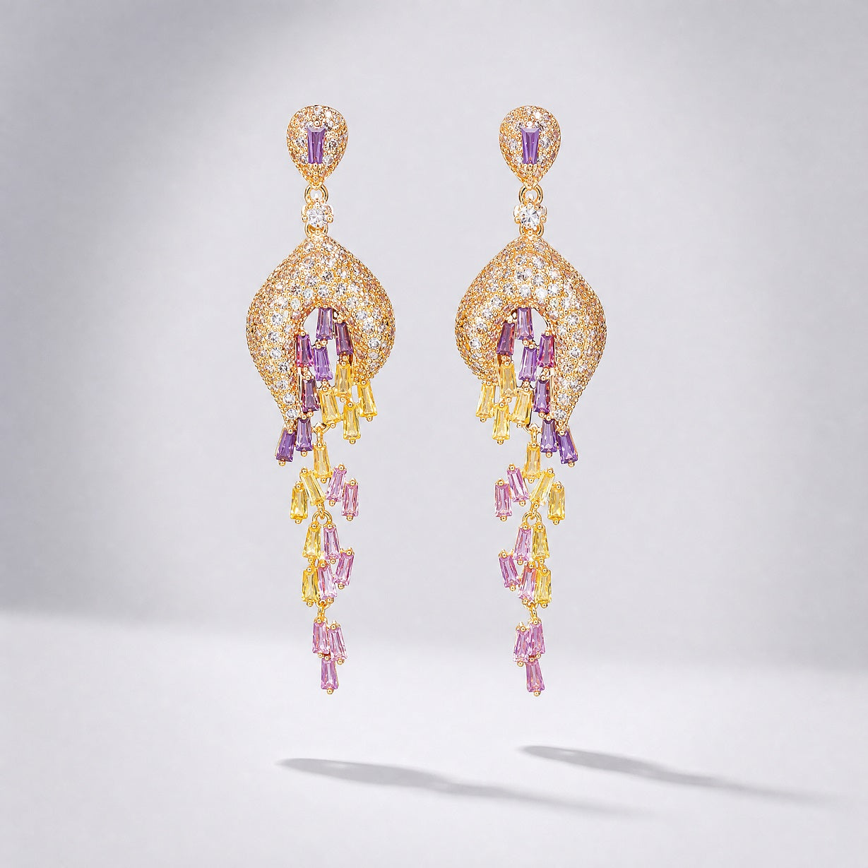 Lyana 7cm long tassel drop earrings with yellow, pink, and lilac baguette-cut cubic zirconia stones on yellow gold metal.