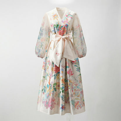 Front view of the Maja Maxi Dress in Cream Botanical print featuring colorful flowers and butterflies with sheer sleeves.
