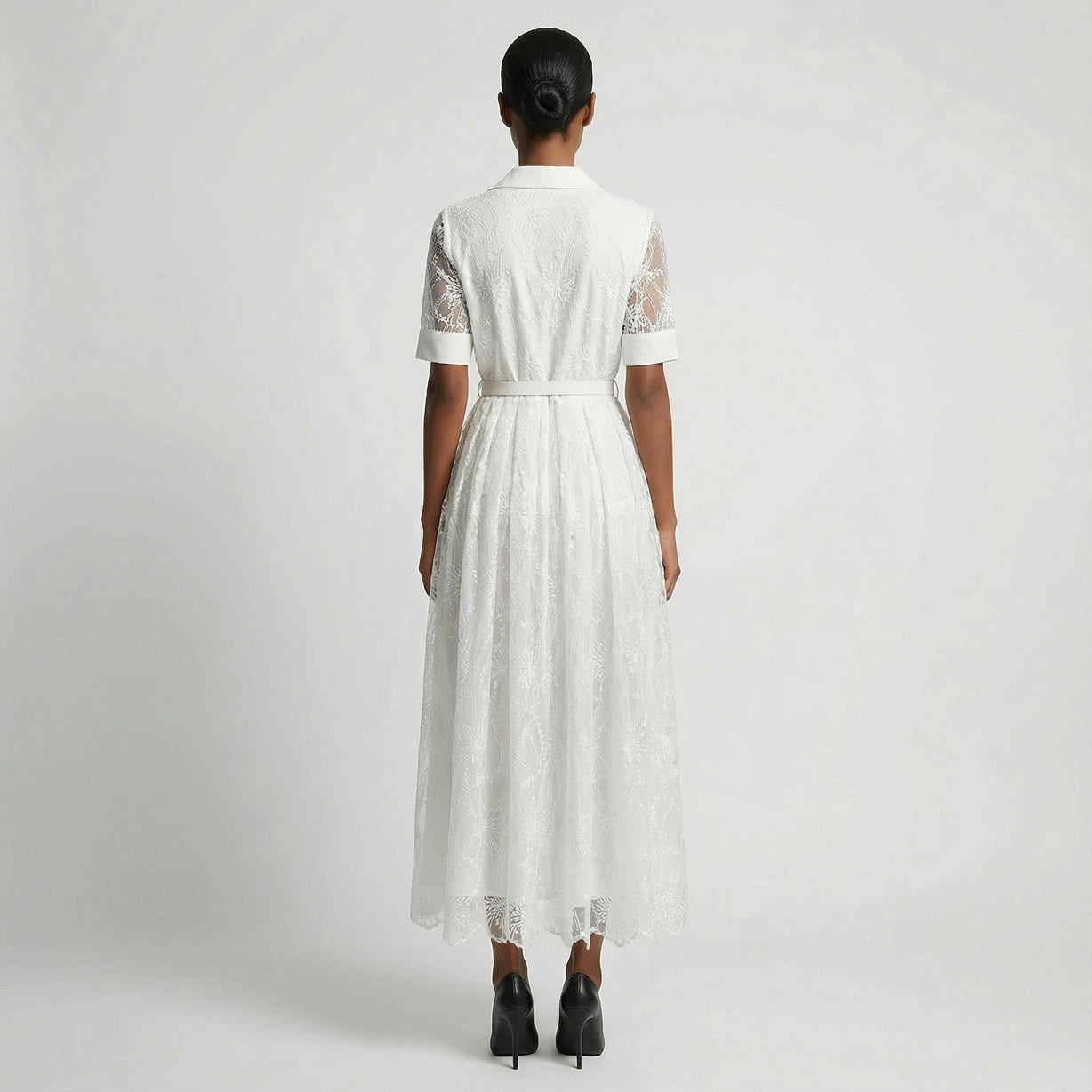 The Margaret dress featuring a long-sleeved ribbed knit bodice and a side-pleated accordion skirt with a matching waist belt in a 135 cm length.
