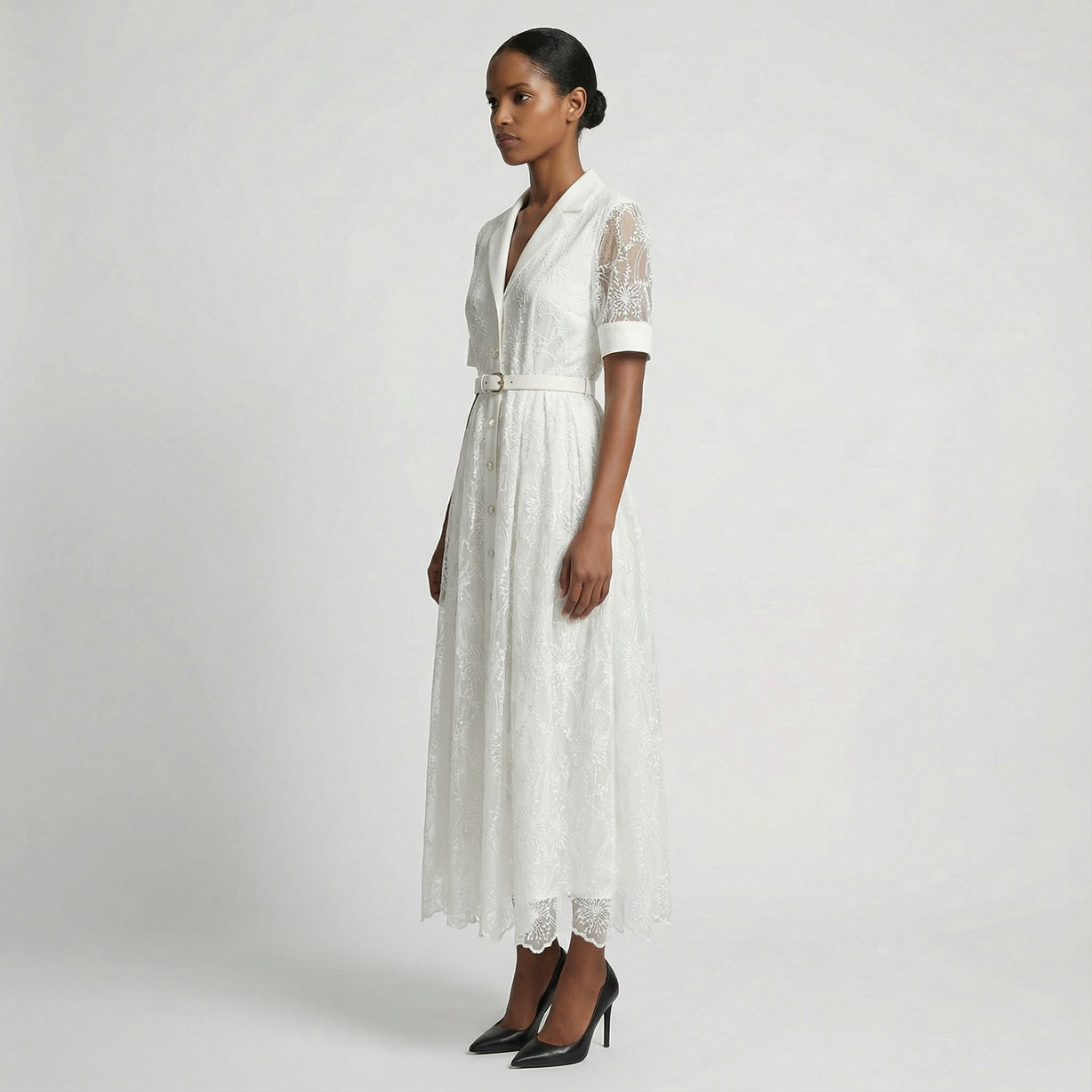 The Margaret dress featuring a long-sleeved ribbed knit bodice and a side-pleated accordion skirt with a matching waist belt in a 135 cm length.