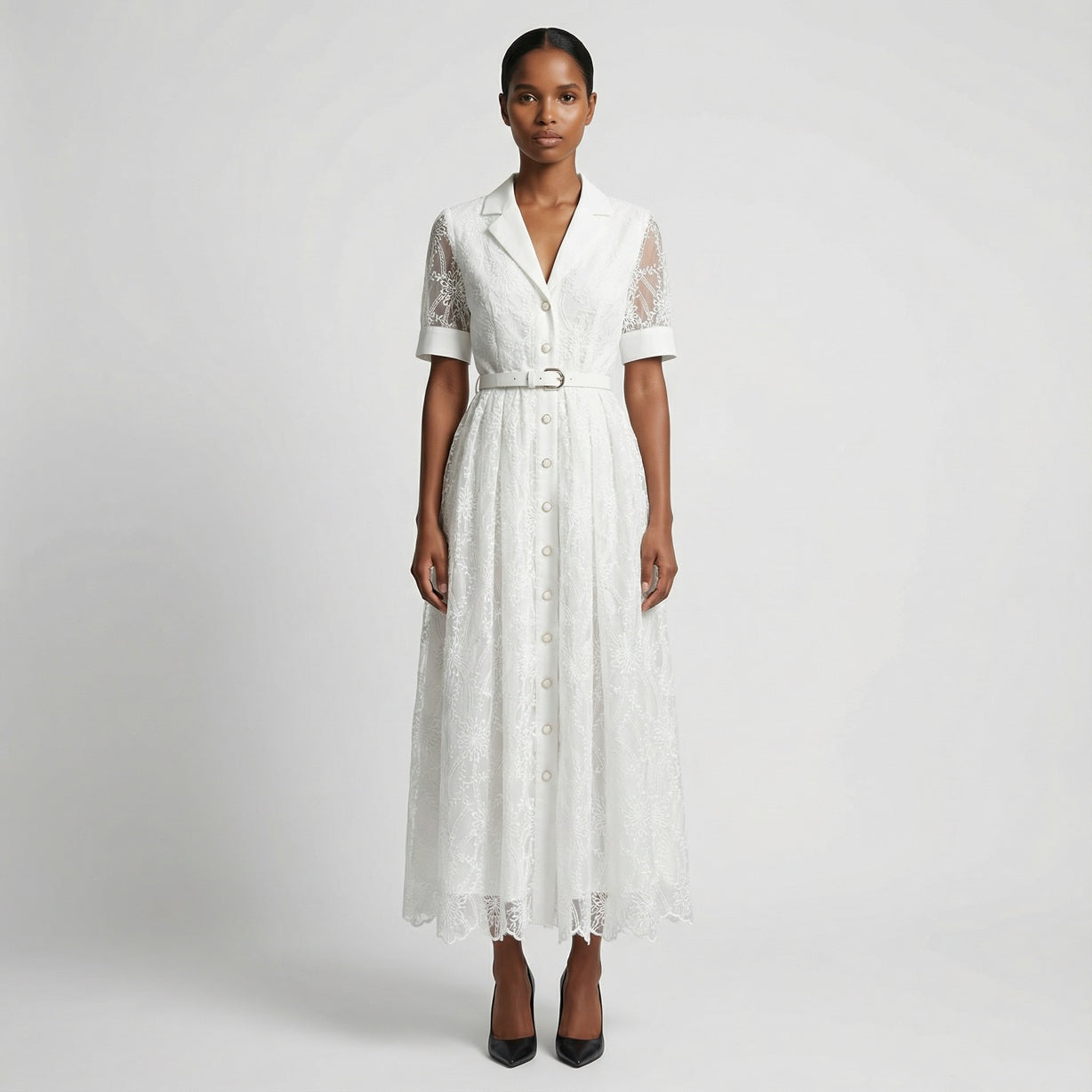 The Margaret dress featuring a long-sleeved ribbed knit bodice and a side-pleated accordion skirt with a matching waist belt in a 135 cm length.