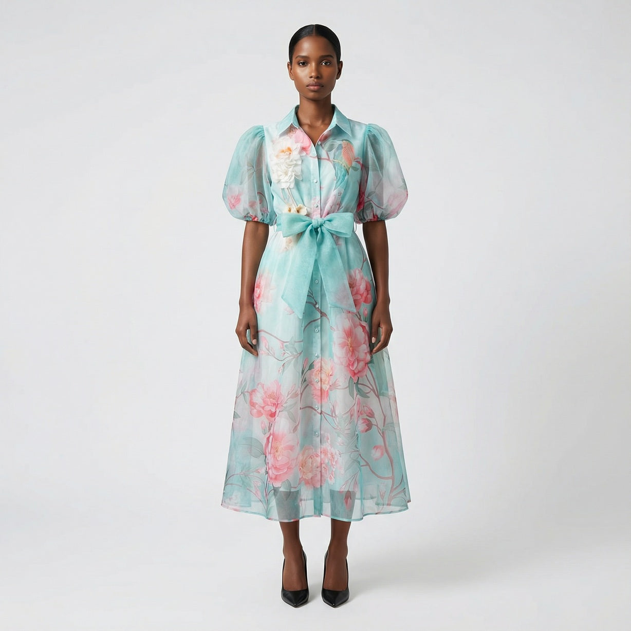 The Marie maxi dress in a 145 cm length featuring a long-sleeved ribbed knit bodice and a dramatic side-pleated accordion skirt with a matching waist belt.