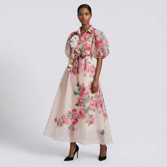 The Marie maxi dress in a 145 cm length featuring a long-sleeved ribbed knit bodice and a dramatic side-pleated accordion skirt with a matching waist belt.