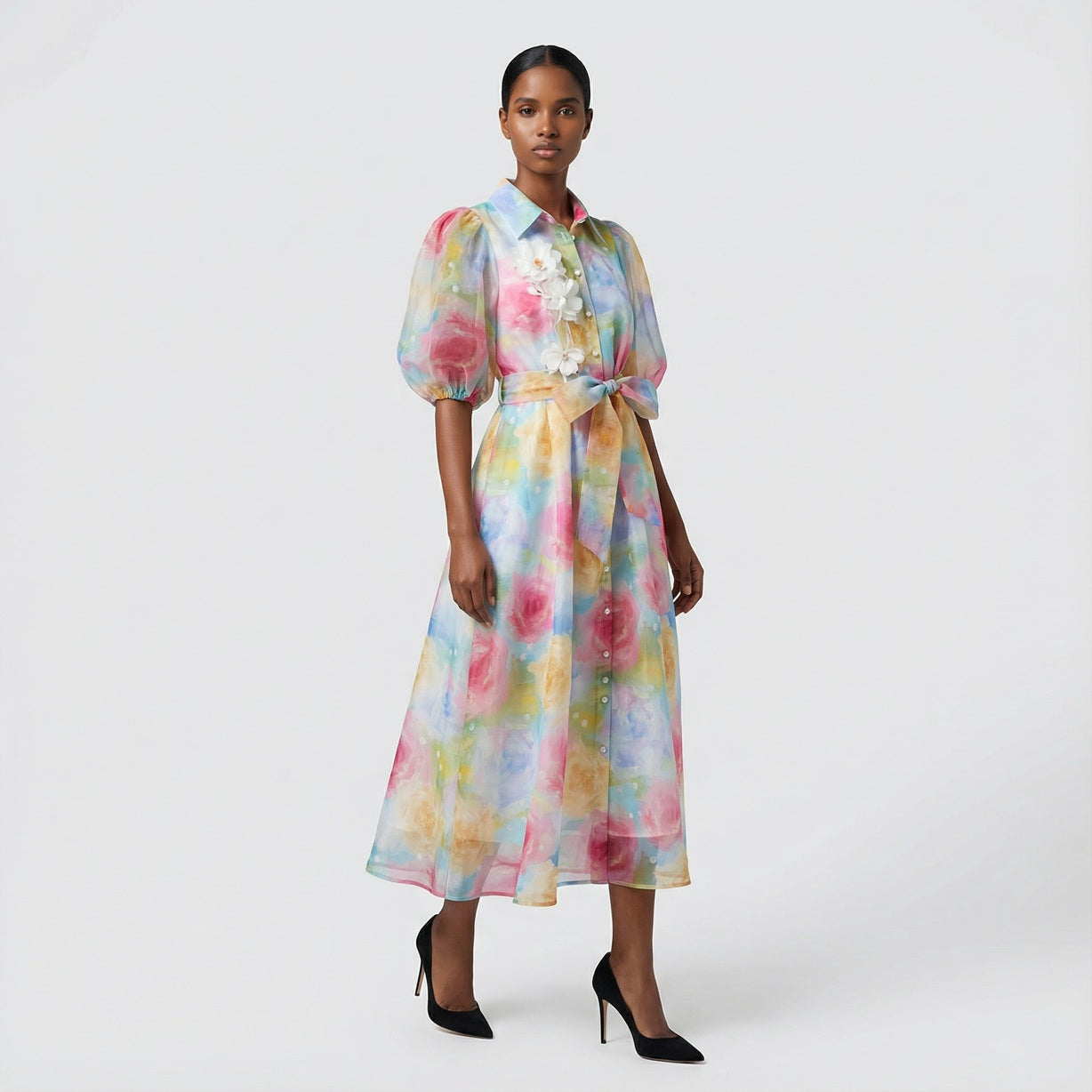 The Marie maxi dress in a 145 cm length featuring a long-sleeved ribbed knit bodice and a dramatic side-pleated accordion skirt with a matching waist belt.