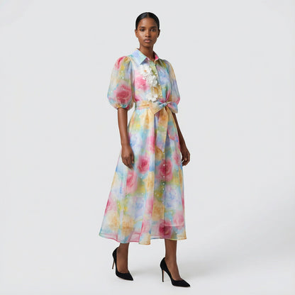 The Marie maxi dress in a 145 cm length featuring a long-sleeved ribbed knit bodice and a dramatic side-pleated accordion skirt with a matching waist belt.