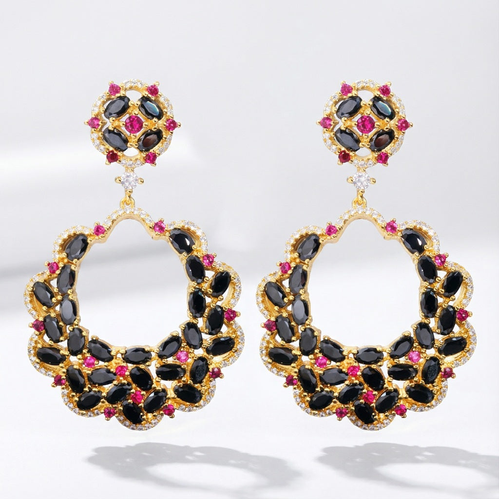 Pair of Miriam statement earrings made of copper, featuring black, pink, and clear AAA+ cubic zirconia stones on a clean studio background