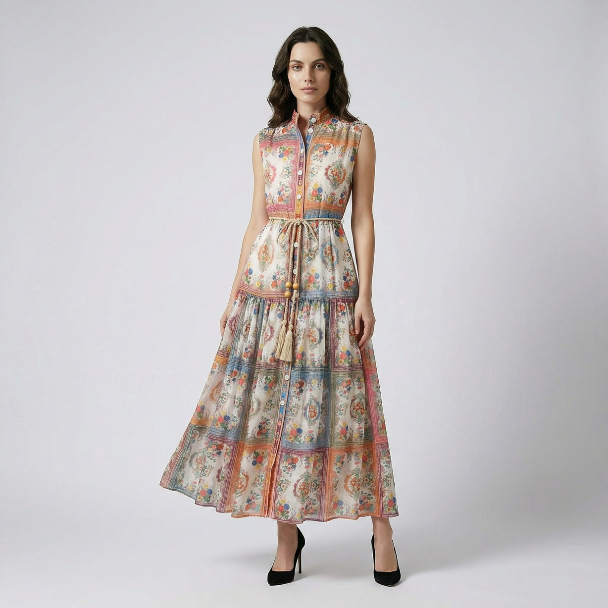 Full length view of the Nichole sleeveless maxi dress featuring a vibrant patchwork floral print and a rope tassel waist belt.