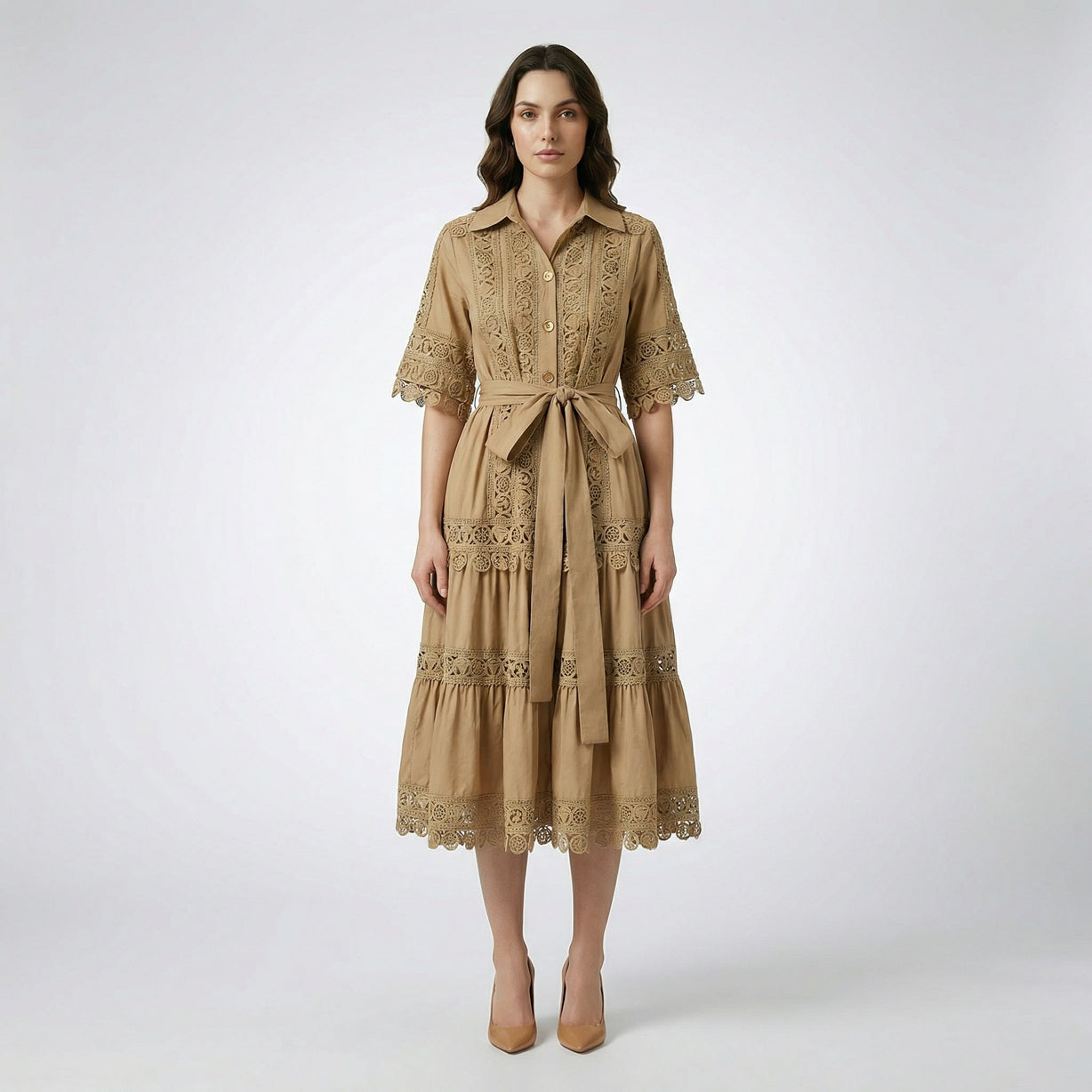 The Noora midi dress shown in black, white, sage green, and camel featuring intricate lace panels, gold buttons, and a matching belt.