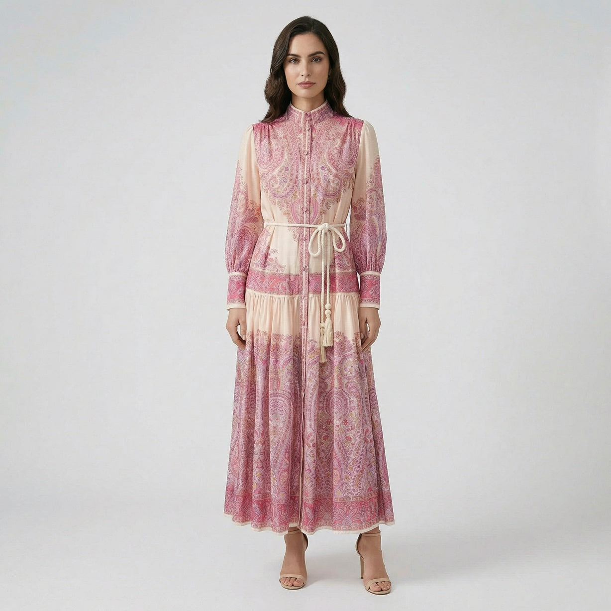 Front view of Olivera pink paisley print maxi dress with white rope tassel belt and lantern sleeves.