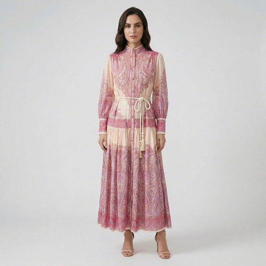 Front view of Olivera pink paisley print maxi dress with white rope tassel belt and lantern sleeves.
