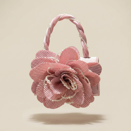 Pink clutch bag with large pink flower and cream pearl details for glamorous evening look