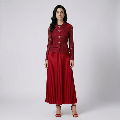 Rachel two-piece set featuring a long-sleeve black lace peplum top with rhinestone bows and a matching black pleated maxi skirt.