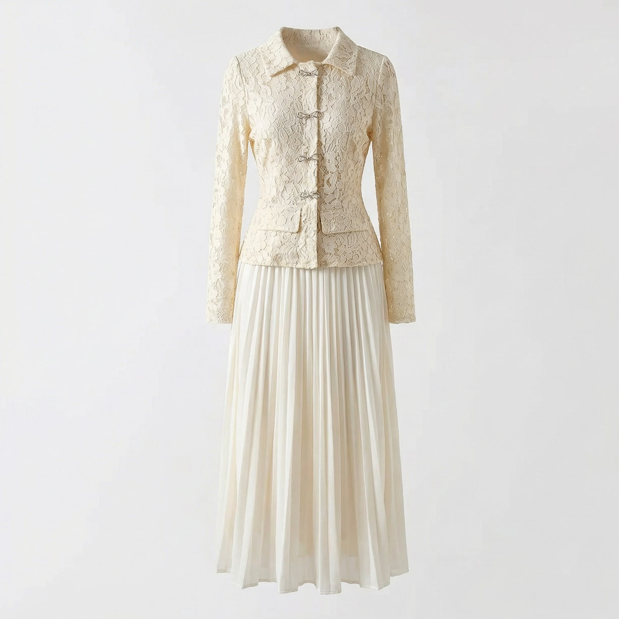 Rachel two-piece set featuring a long-sleeve black lace peplum top with rhinestone bows and a matching black pleated maxi skirt.