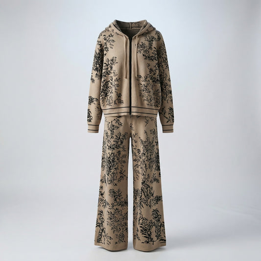 Rafaella two-piece knit tracksuit featuring a black floral jacquard pattern on a grey, cream, black, and beige background.