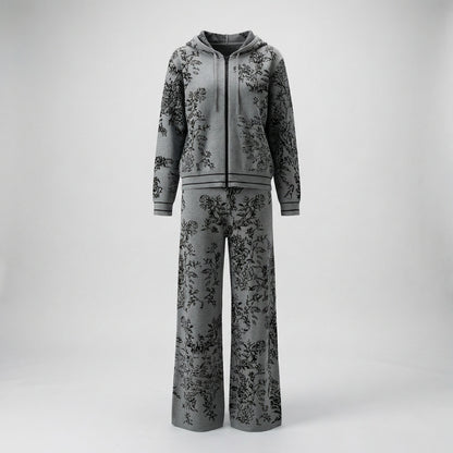 Rafaella two-piece knit tracksuit featuring a black floral jacquard pattern on a grey, cream, black, and beige background.