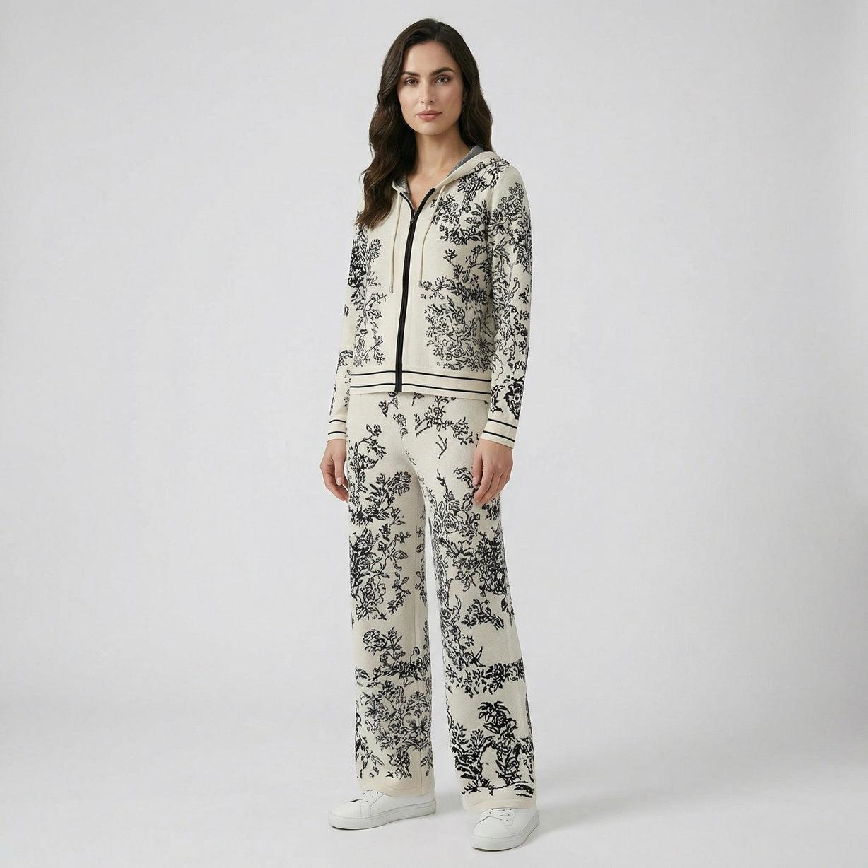 Rafaella two-piece knit tracksuit featuring a black floral jacquard pattern on a grey, cream, black, and beige background.