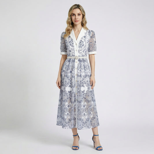 Front view of a woman wearing the Ruxandra navy blue floral lace midi-maxi dress with white lapel and pearl belt.