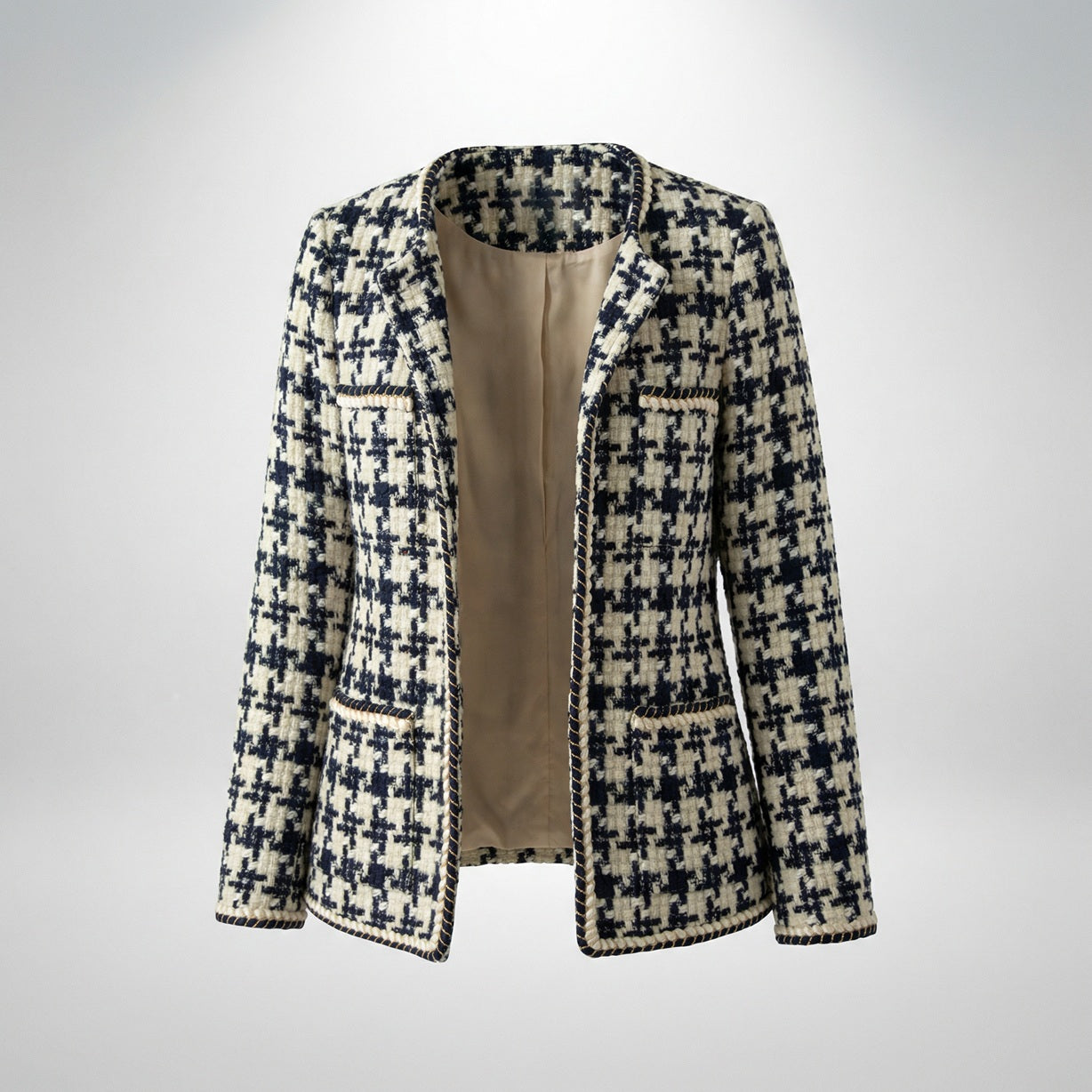 Close-up of Selina navy and cream houndstooth tweed jacket featuring gold braided trim and four front pockets.