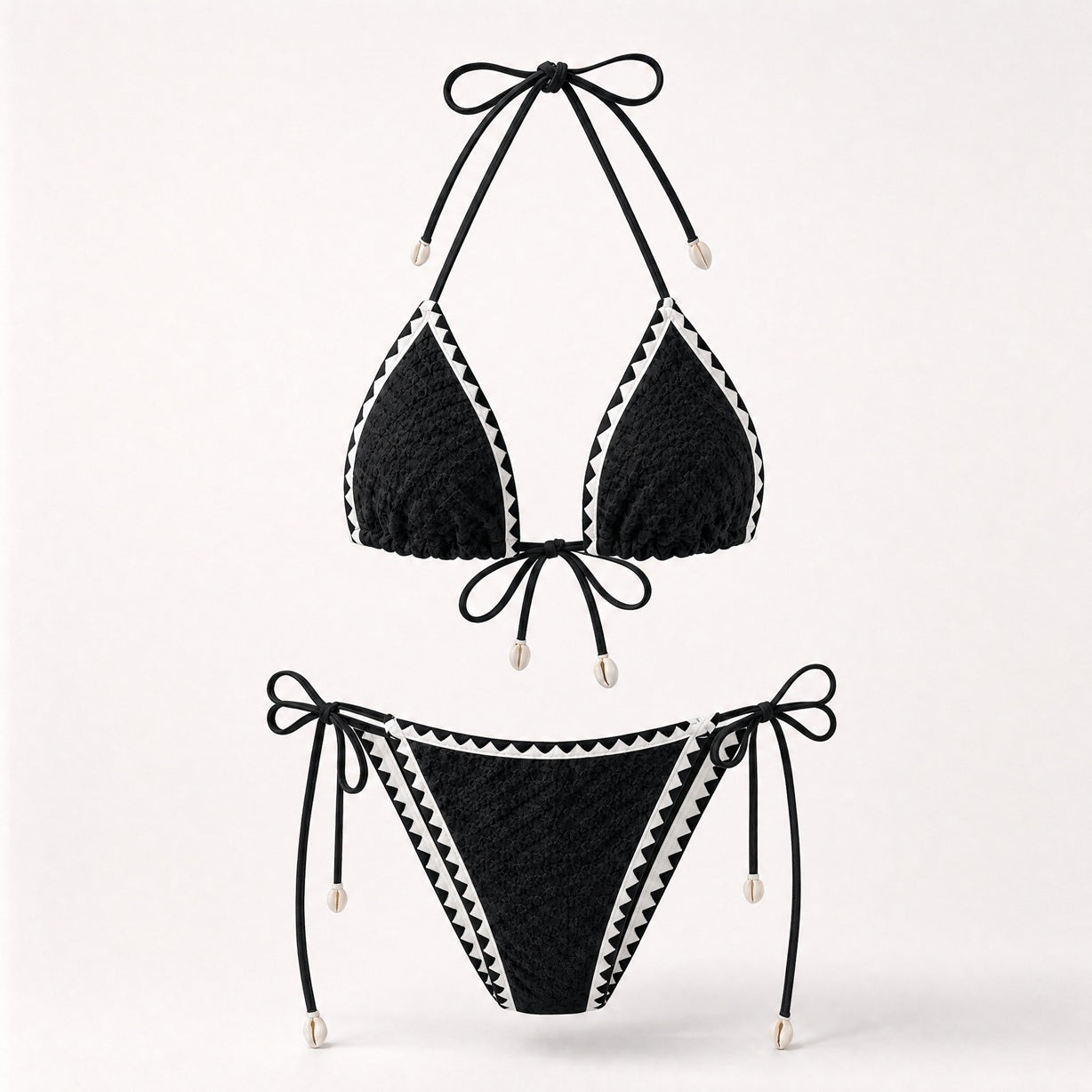 Classic black textured bikini with white zig-zag trim and shells.