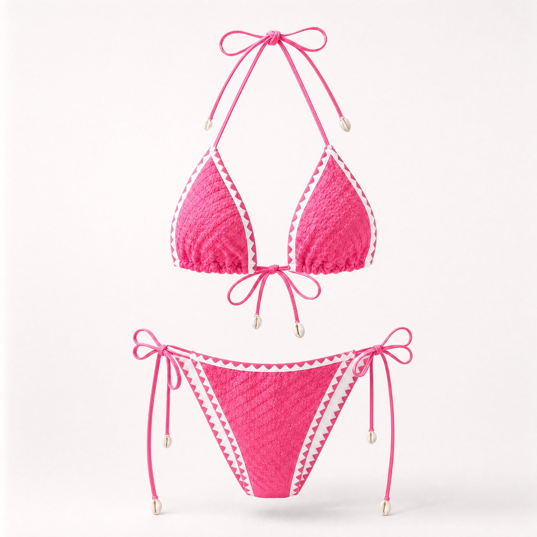 Bright pink popcorn fabric bikini set with cowrie shell accents.
