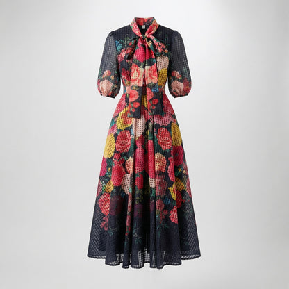Solange 53-inch maxi dress featuring a sheer white plaid organza fabric with pink floral print and a pussy-bow neckline.