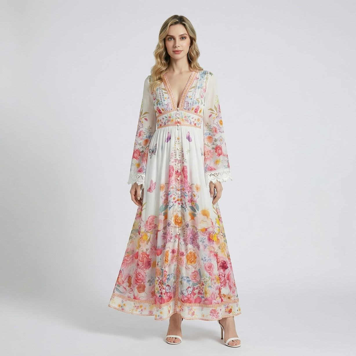 Sonya maxi dress in blue and pink floral print featuring long bell sleeves with white lace trim and button-down front.