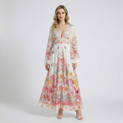 Sonya maxi dress in blue and pink floral print featuring long bell sleeves with white lace trim and button-down front.