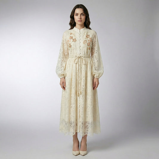 Full-length view of the Suzette cream lace maxi dress featuring floral embroidery, sequins, and a rope tie belt.