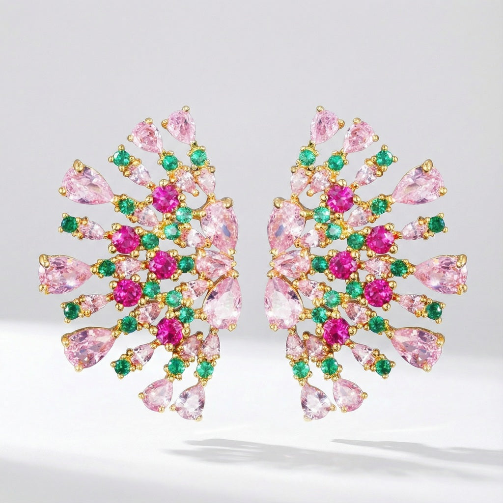 Pair of Teodora statement fan-shaped earrings featuring pink, fuchsia, and emerald green AAA+ cubic zirconia stones on a gold-tone background