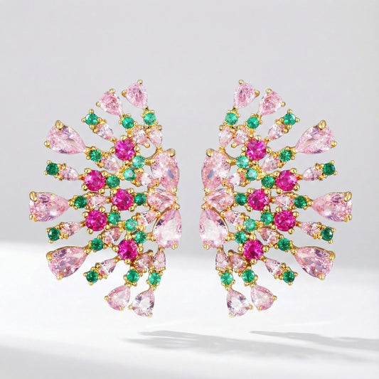 Pair of Teodora statement fan-shaped earrings featuring pink, fuchsia, and emerald green AAA+ cubic zirconia stones on a gold-tone background
