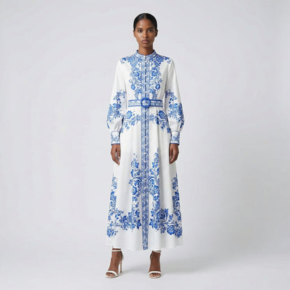 Front view of the Teresa maxi dress in white with blue porcelain floral print, featuring long lantern sleeves and a matching blue belt