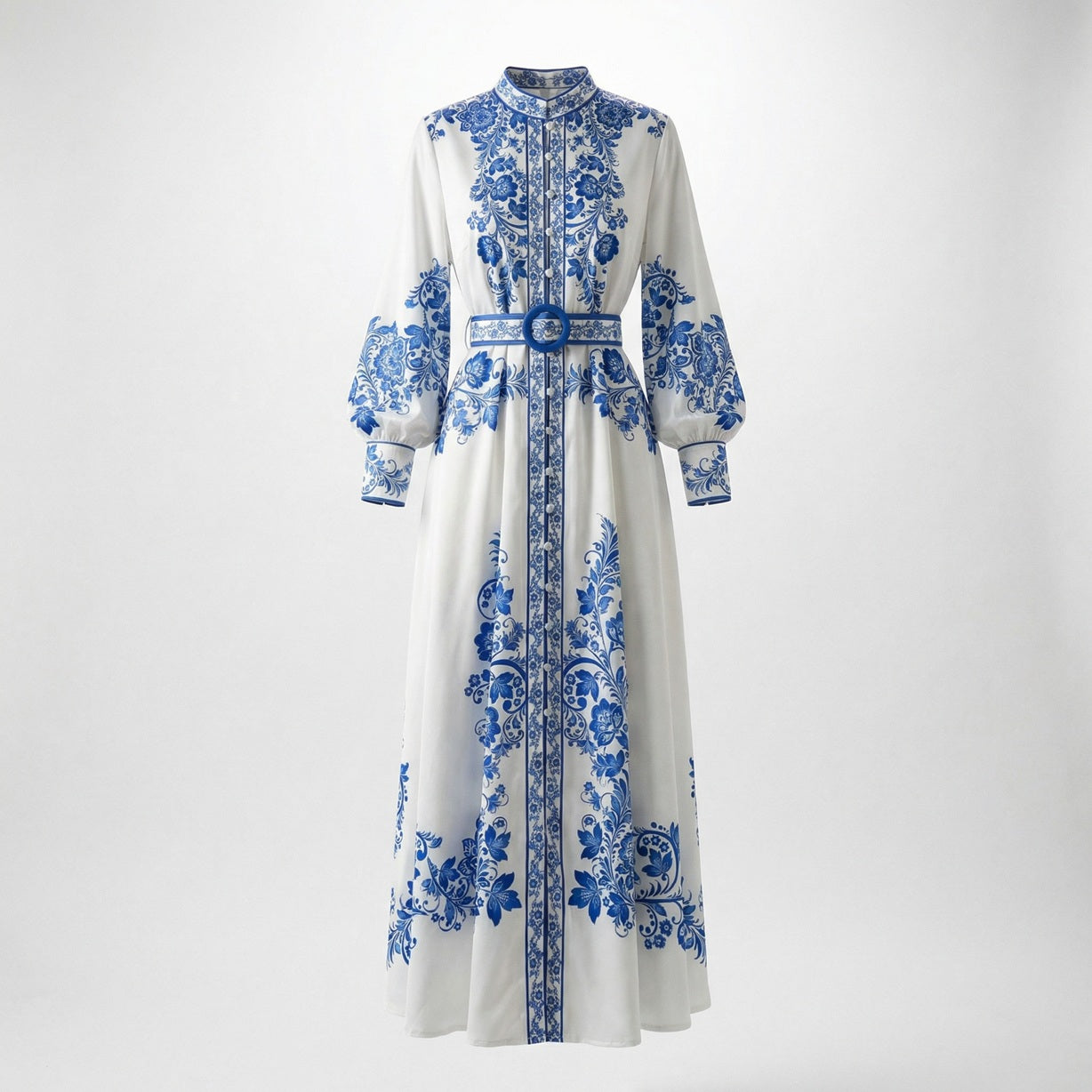 Front view of the Teresa maxi dress in white with blue porcelain floral print, featuring long lantern sleeves and a matching blue belt