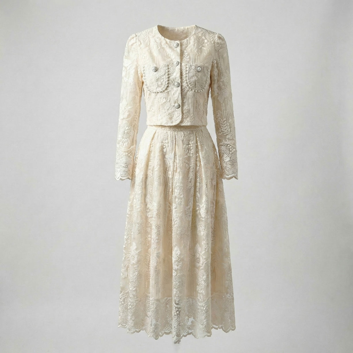 Thelma two-piece set featuring a pink floral lace cropped jacket with large pearl buttons and a matching 75cm midi skirt.