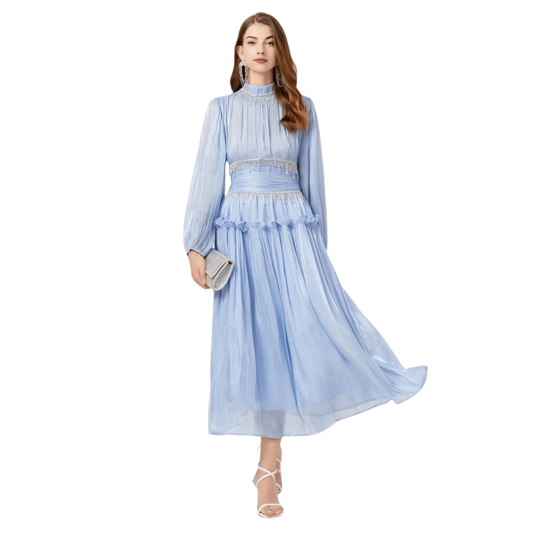 The Victoria maxi dress shown in black, blue, and pink featuring rhinestone fringe waist detailing and long sheer sleeves.