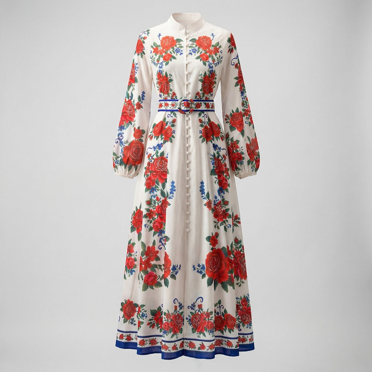 Front view of Yuliana ivory maxi dress with large red rose print, lantern sleeves, and a matching floral belt with blue trim
